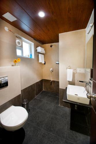 a bathroom with a toilet and a sink at Raj Residency in Bengaluru