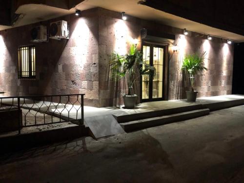 a building with potted plants in front of a door at Street51 in Yerevan