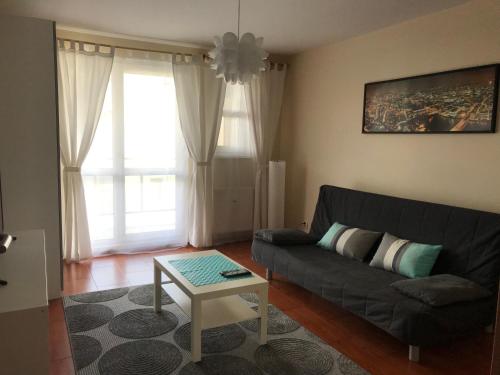 a living room with a couch and a table at Apartament Sloneczny Taras in Olsztyn