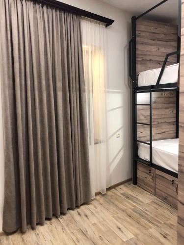 a bedroom with a curtain and a bunk bed at Street51 in Yerevan