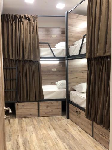 a room with three bunk beds in it at Street51 in Yerevan