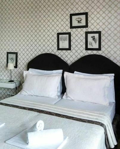 a bedroom with a bed with white sheets and pillows at Belle Apartments-Elegance Apartments in Belgrade
