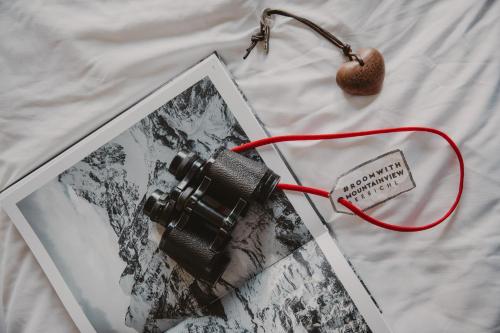 a camera and a picture on a bed at SEEBICHL haus am see Designhotel Kitzbühel in Kitzbühel