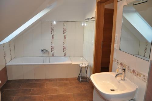 a bathroom with a bath tub and a sink at Haaghof Ertl in Ertl