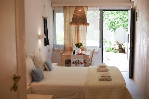 a bedroom with a bed in a room with a window at Villa Iokasti in Hersonissos