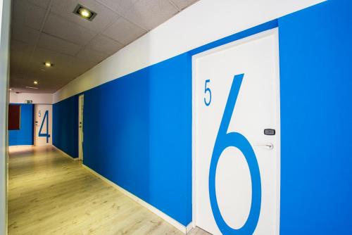 an empty hallway with blue doors in a building at Safestay Madrid Central in Madrid