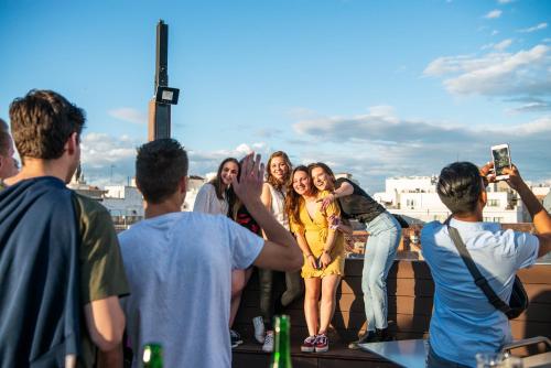 a group of people posing for a picture on a rooftop at Safestay Madrid Central in Madrid