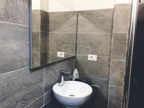 a bathroom with a sink and a mirror at Aloha House in Formia