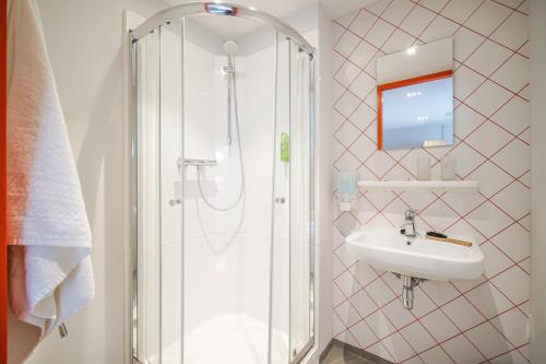 a bathroom with a shower and a sink at Via Amsterdam in Amsterdam