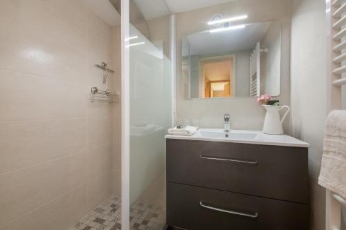 a bathroom with a sink and a mirror at Résidence Grand Roc - Bruyères 119 in Chamonix-Mont-Blanc