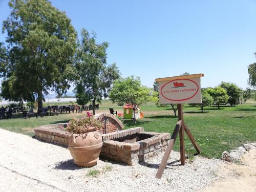 a sign in front of a park with a fountain at Agriturismo Le Folaghe in Terracina