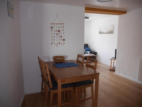 a dining room with a wooden table and chairs at Alte Schmiede Sagard in Sagard