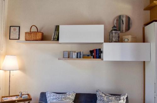 a living room with shelves on the wall at Casa Del Cavaliere in La Spezia