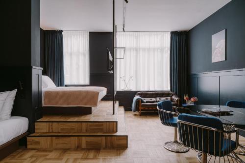 a bedroom with a bed and a living room at Supernova Hotel in Rotterdam