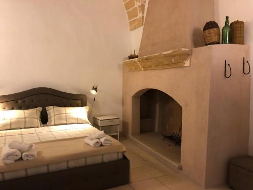 Ένα ή περισσότερα κρεβάτια σε δωμάτιο στο Masseria Mattiani