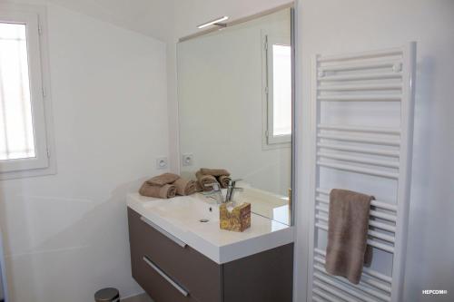 a bathroom with a sink and a mirror at BASTIDE 7 in La Fare-les-Oliviers