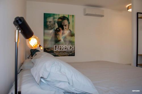 a bedroom with a movie poster on the wall and a bed at BASTIDE 7 in La Fare-les-Oliviers
