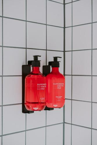 two red fire hydrants on a tile wall at Supernova Hotel in Rotterdam