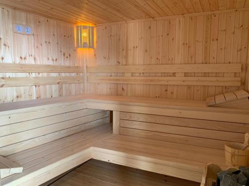 a wooden sauna with a bench in it at Hotel Grandpa's House in Shkodër