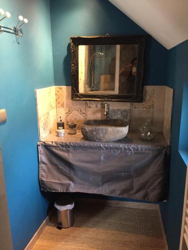 W łazience znajduje się umywalka i lustro. w obiekcie Gite L'Atelier w mieście Bèze