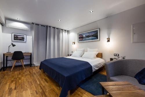 a hotel room with a bed and a couch at Les suites sainte claire in Annecy