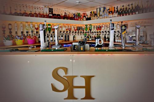 a bar with the s bar logo on it at Stuart hotel in Blackpool
