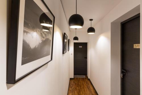 a hallway with two pendant lights and a hallway with a hallway sidx sidx sidx at Les suites sainte claire in Annecy