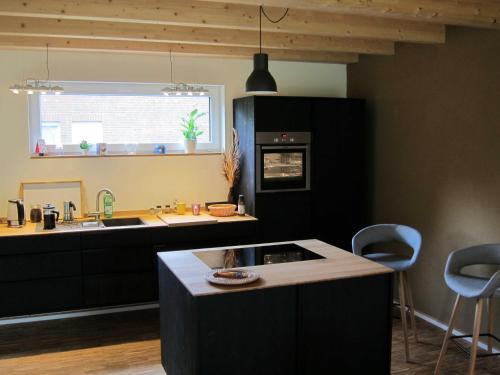a kitchen with a sink and a counter top at Haus am See in Rieste
