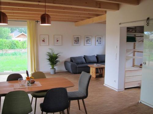 a living room with a table and a couch at Haus am See in Rieste