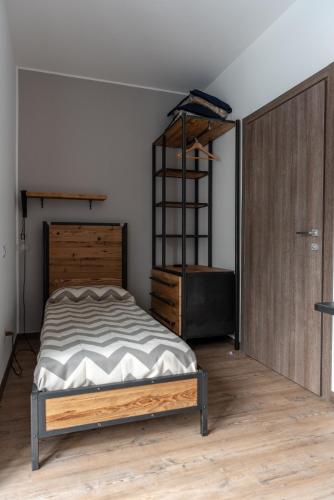 a bedroom with a bed and a dresser at Officina Rooms in Como