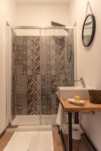 a bathroom with a shower with a glass door at Officina Rooms in Como