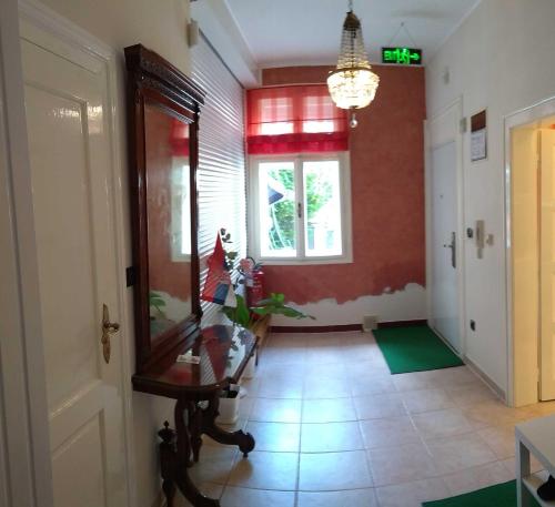 a hallway with a room with a table and a window at Resident hill resort in Belgrade