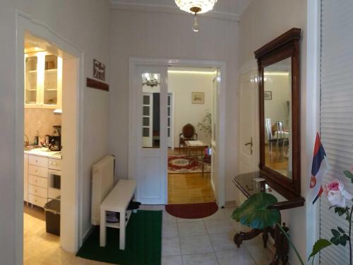 a kitchen with a hallway with a table and a chair at Resident hill resort in Belgrade