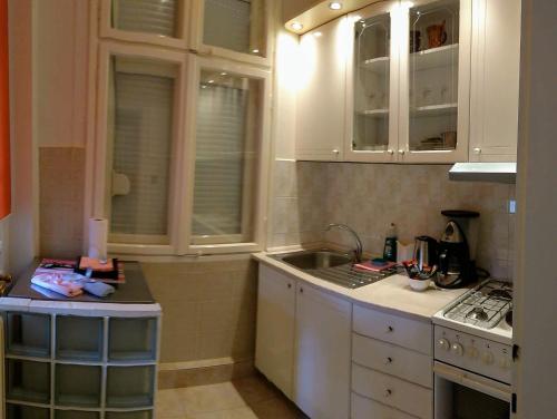 a kitchen with white cabinets and a sink at Resident hill resort in Belgrade