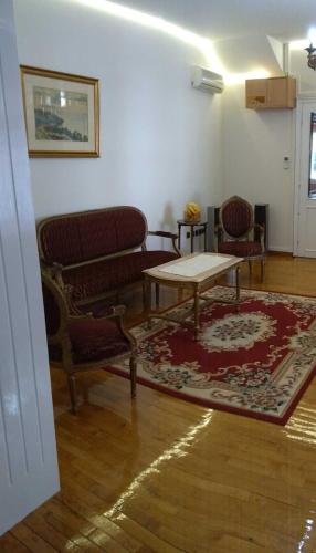 a living room with chairs and a table and a rug at Resident hill resort in Belgrade