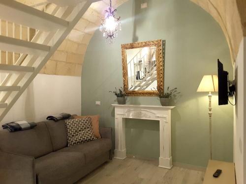 a living room with a couch and a mirror at SASSO BIANCO in Matera