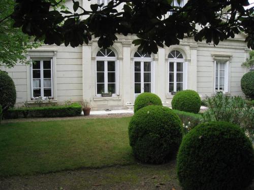 a white house with bushes in front of it at Le Belvédère,double room in Bléré