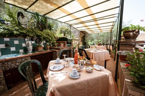 a dining room with tables and chairs in a restaurant at B&B Panorama in Castelbuono
