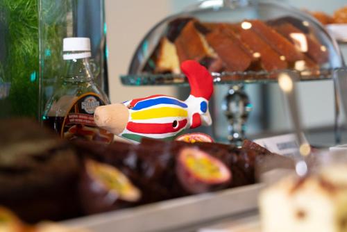 a close up of chocolate covered donuts with a toy at Hotel Nazionale in Matera