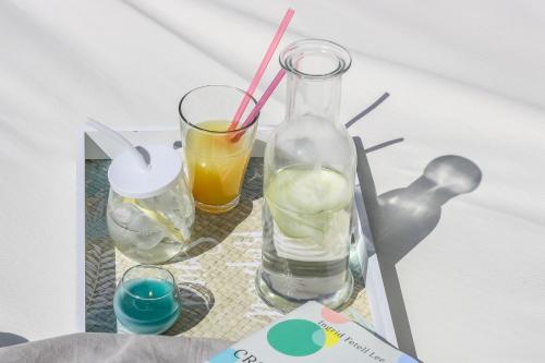 two glasses and a bottle of water and a drink at Luxury Summer House in La Spezia