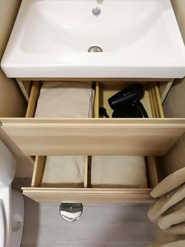 a drawer with a white sink in a bathroom at Apartamentos Playa Benitez in Ceuta