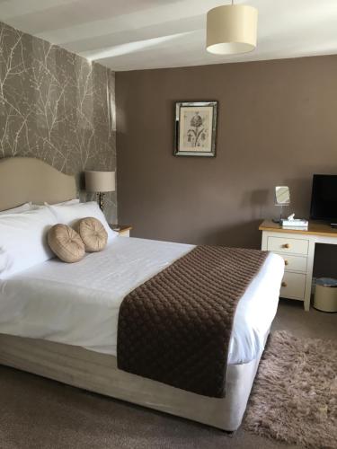 a bedroom with a large white bed with pillows at Rye Flatt Bed and Breakfast in Colne