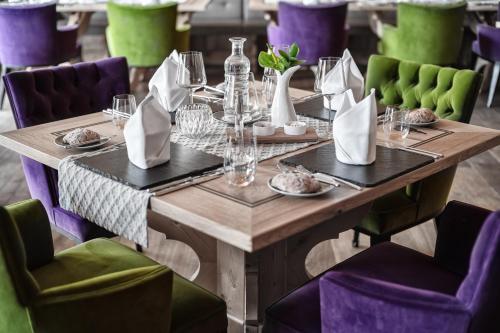 a wooden table in a restaurant with chairs at Cocoon - Alpine Boutique Lodge in Maurach