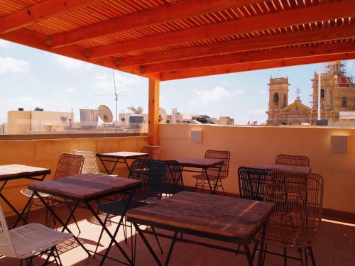 a patio with tables and chairs and a view of the city at Provicario in Victoria