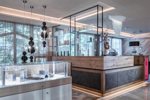 a room with a glass case with books on a counter at Cocoon - Alpine Boutique Lodge in Maurach