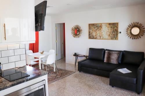 a living room with a couch and a table at Captiva Beach Resort (open private beach access) in Sarasota