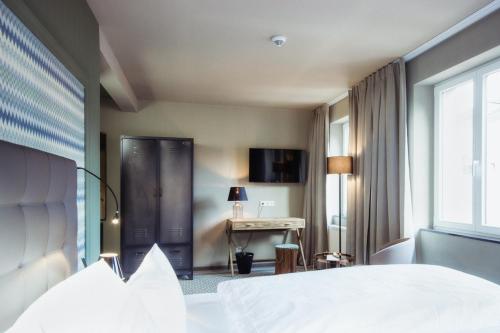 Ένα ή περισσότερα κρεβάτια σε δωμάτιο στο Hotel Goldene Traube - by Neugart
