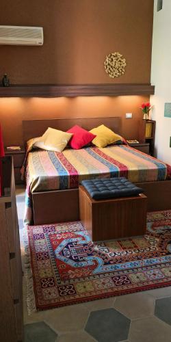 a bedroom with two beds and a rug at Casa Vacanze Archi Medievali in Salerno