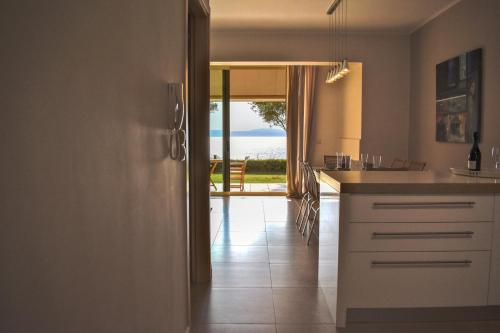 a kitchen with a counter and a view of the ocean at AVIA HOLIDAY HOME 2 in Avia