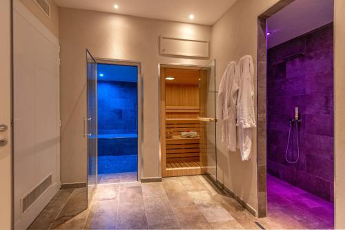 a bathroom with a walk in shower and a glass door at Borgo di Villa Cellaia Resort & SPA in Dicomano